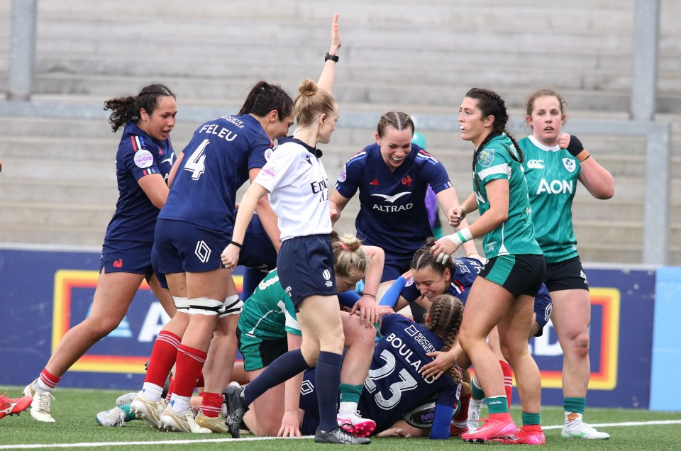 France's Emilie Boulard is congratulated after scoring a late try during the Women's Six Nations international rugby union match between Ireland and France at the Kingspan Stadium in Belfast, on March 22, 2025. (Photo by Paul Faith / AFP) (Photo by PAUL FAITH/AFP via Getty Images)